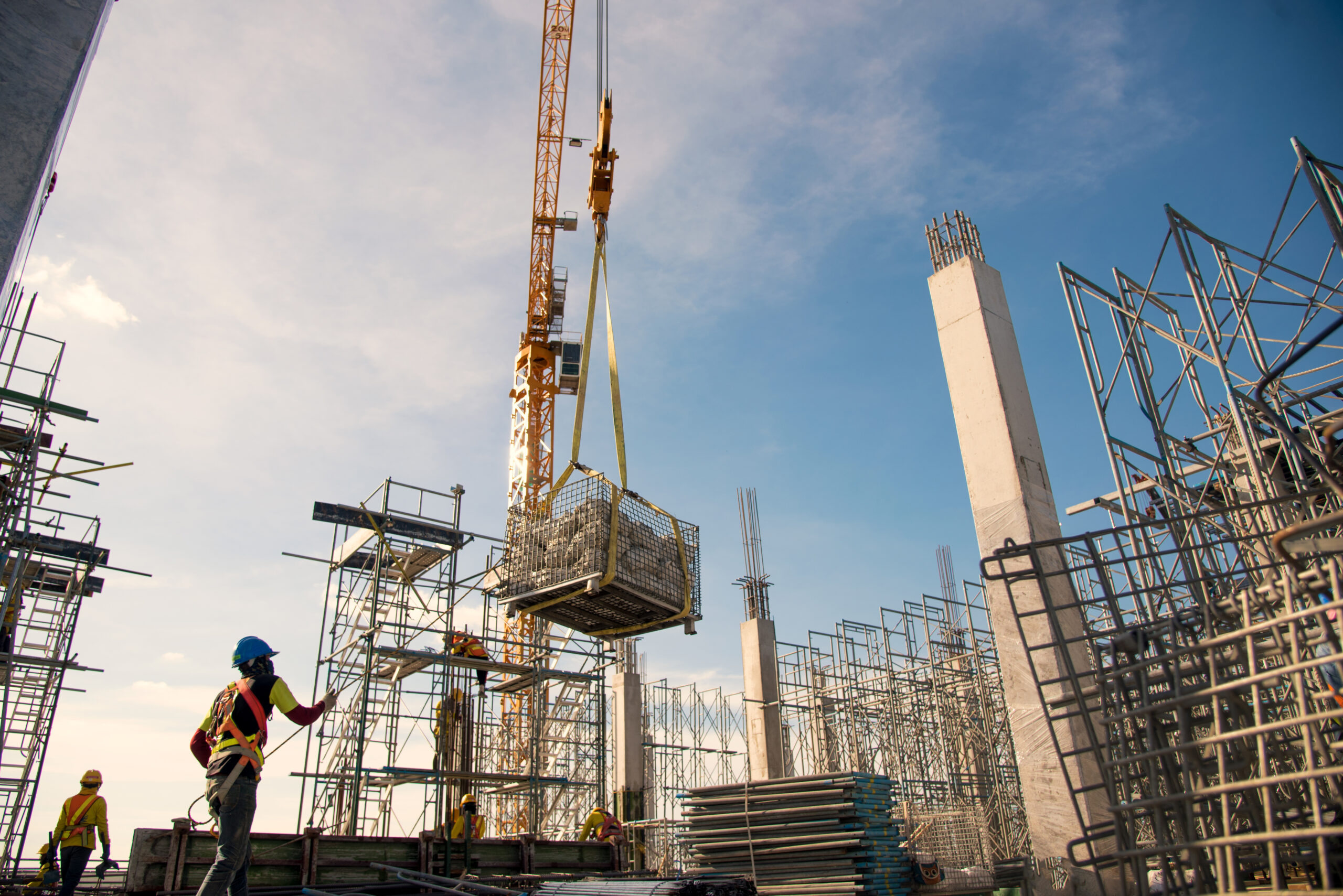 group of worker in safety uniform install reinforced steel column in construction site during sunset time industrial concept