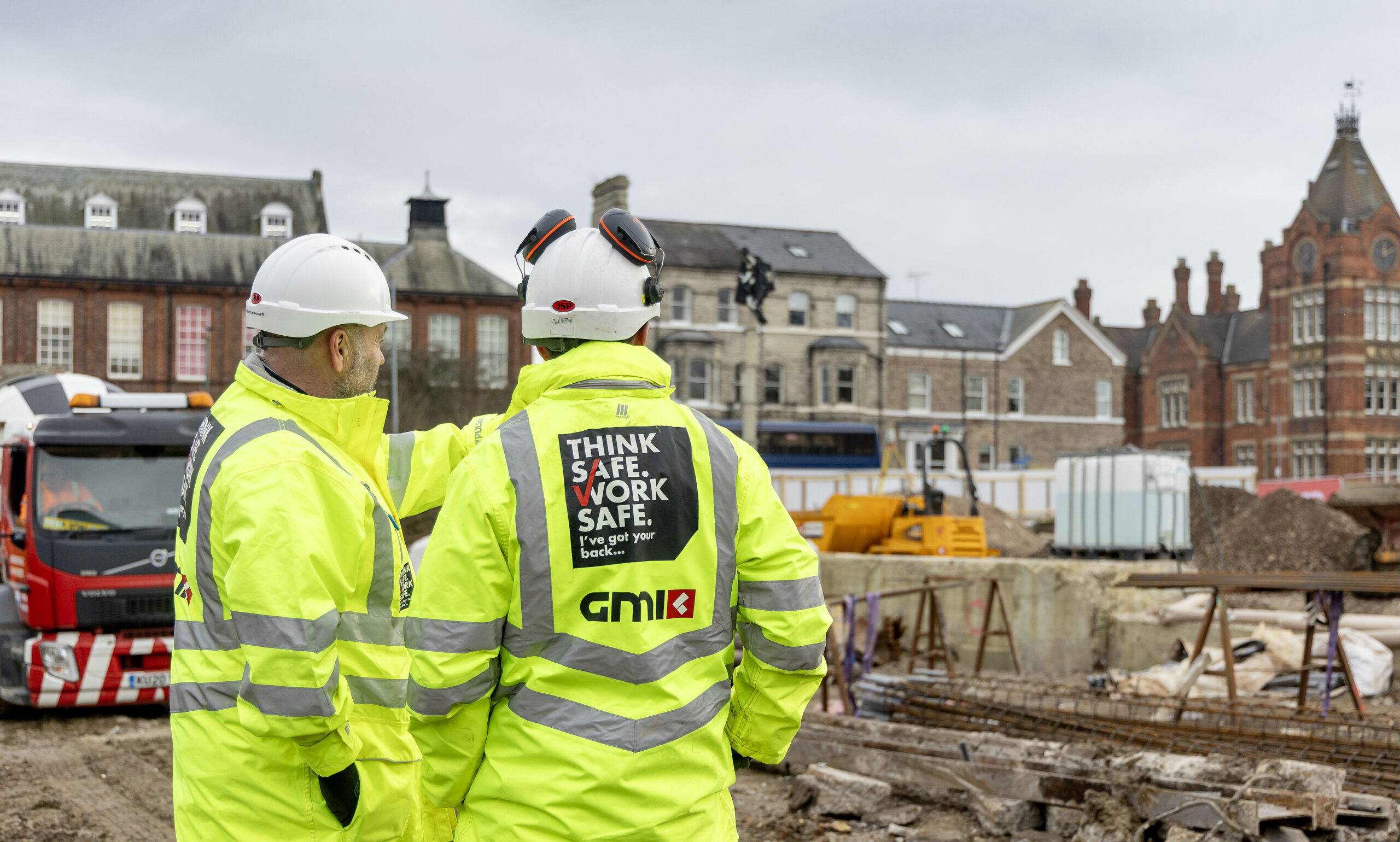 Construction workers on site discussing the project